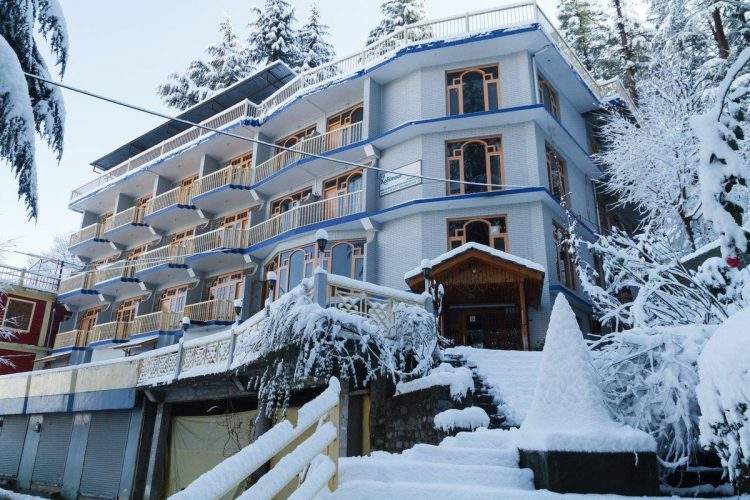Exterior of Kohinoor Hotel with snow in Naggar Manali
